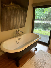 66” Porcher cast iron bathtub with clawfoot legs and polished chrome fixtures
