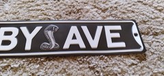 Shelby Ave Metal Sign Snake Logo Black and White Decor Wall Art 20 x 3.33in