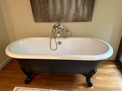 66” Porcher cast iron bathtub with clawfoot legs and polished chrome fixtures